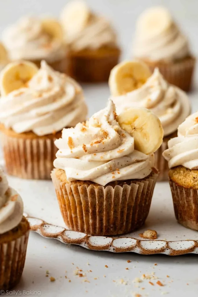 Banana cupcakes with cinnamon cream cheese frosting on a plate