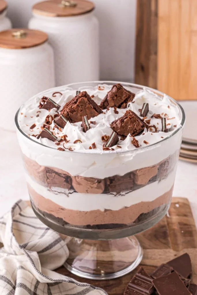 Decadent brownie trifle with layers of brownies, cream, and chocolate.