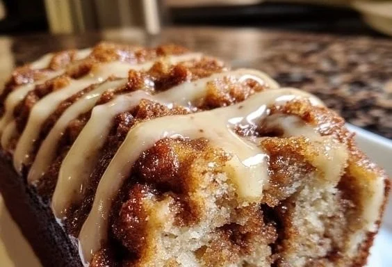 Freshly baked cinnamon roll banana bread with cinnamon swirl topping