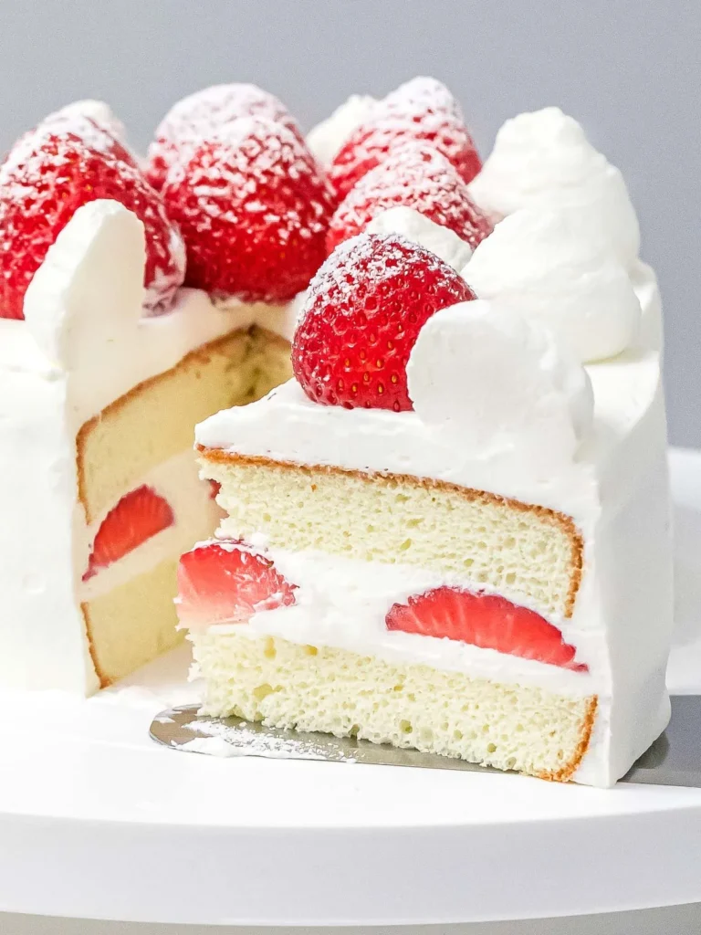 A beautiful slice of Japanese strawberry shortcake topped with fresh strawberries.