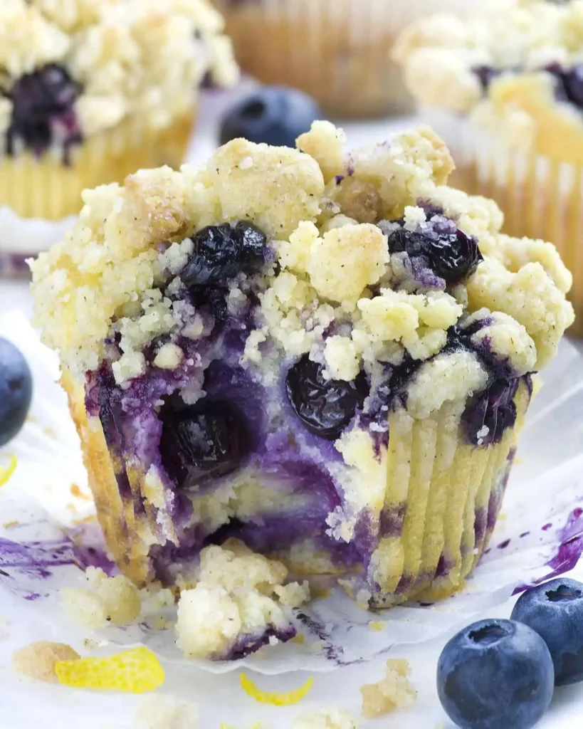 Freshly baked lemon blueberry muffins with a golden top and blueberries