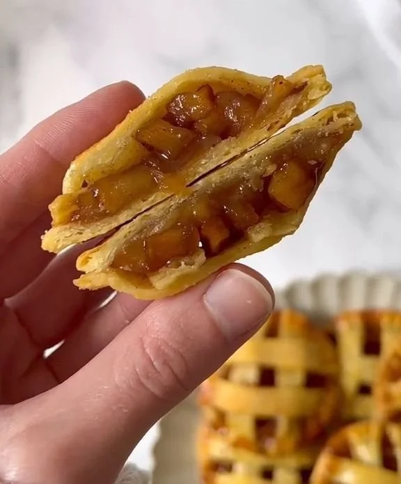 Plate of mini apple pies with golden crust and apple filling