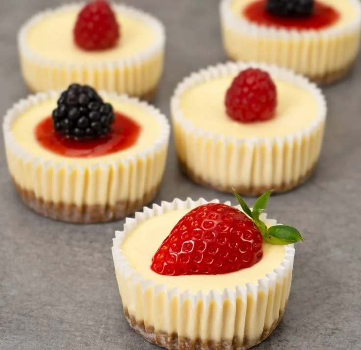 Delicious mini cheesecakes topped with fresh fruit and chocolate