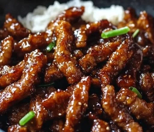 Delicious sticky honey garlic pork served with vegetables and rice.