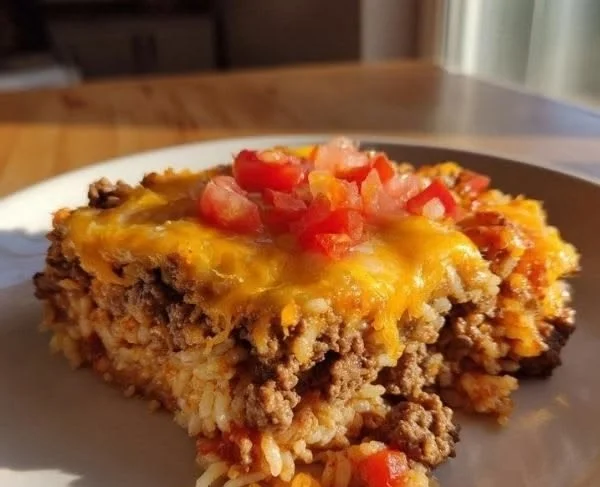 Cheesy Hamburger Rice Casserole served in a baking dish with melted cheese on top