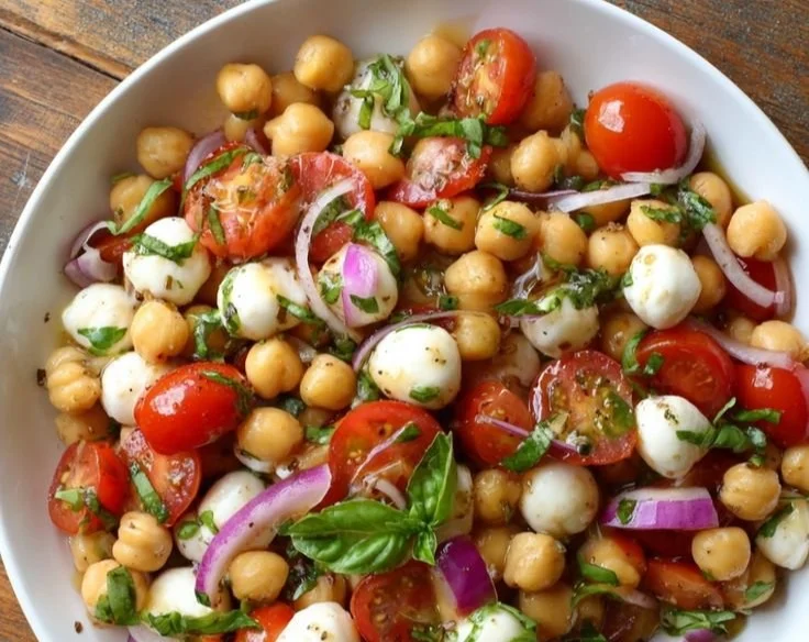 Chickpea Caprese Salad with fresh tomatoes, mozzarella, and basil in a bowl