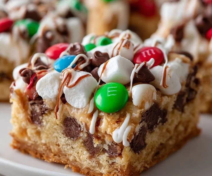 Christmas chocolate marshmallow M&M bars topped with creamy chocolate and colorful candies