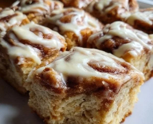 Delicious homemade cinnamon roll dessert bars on a white plate