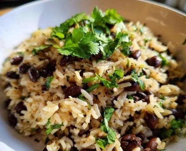 Delicious Coconut Rice and Beans served in a bowl with fresh herbs