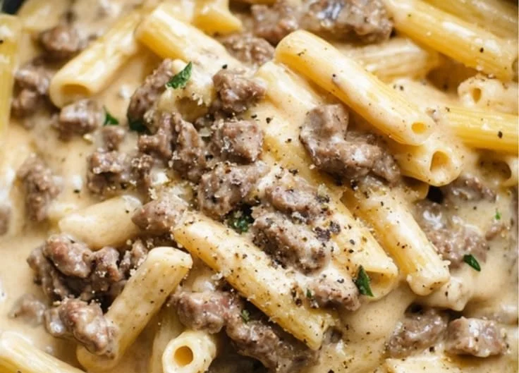 Delicious creamy beef pasta served in a bowl with garnishes