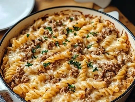 Creamy ground beef pasta dish served in a bowl with herbs