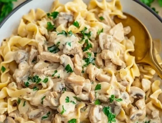 Ground turkey stroganoff served on a plate with mushrooms and noodles