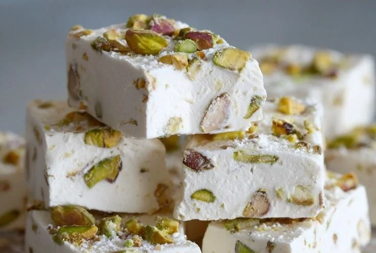 Homemade soft and chewy pistachio nougat with nuts