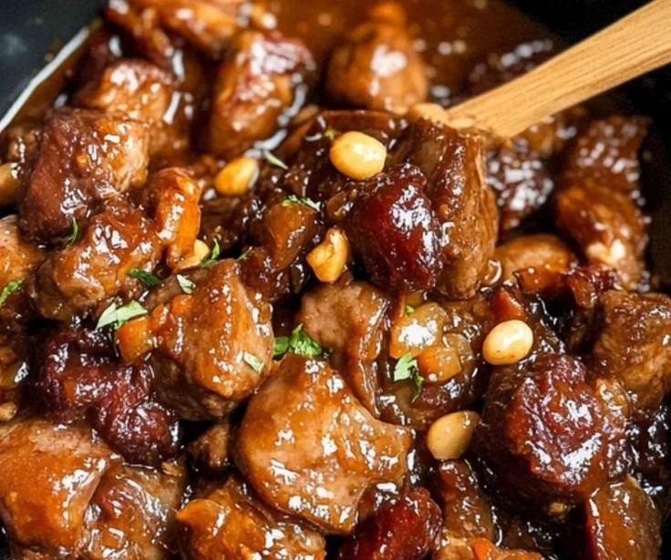 Delicious Jamaican Oxtail dish served with rice and peas.