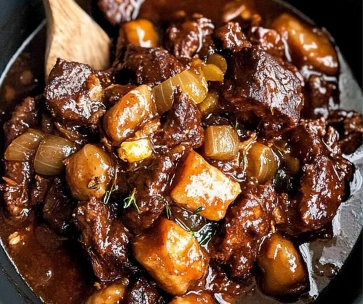 A plate of authentic Jamaican Oxtail served with rice and peas.