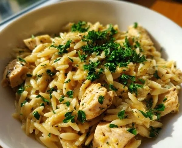 Plate of Lemon Chicken with Orzo garnished with parsley