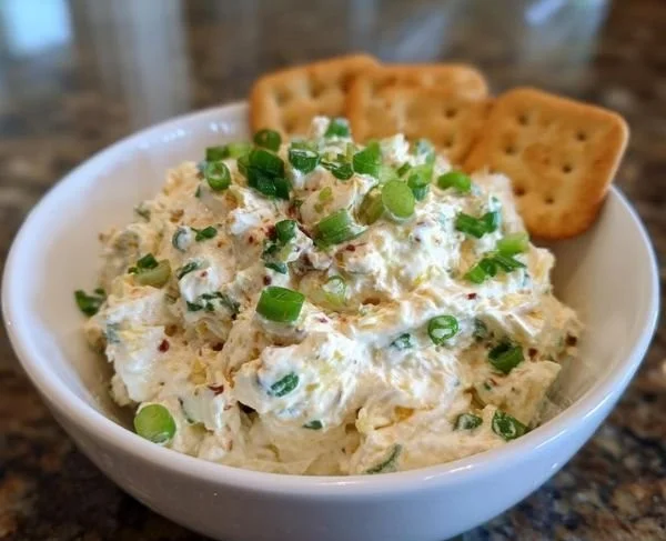 Delicious roasted jalapeño cream cheese spread served in a rustic bowl.
