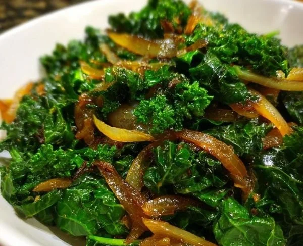 Delicious sauteed kale with caramelized onions served in a bowl