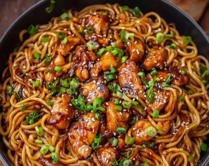 Delicious sticky garlic chicken noodles served in a bowl