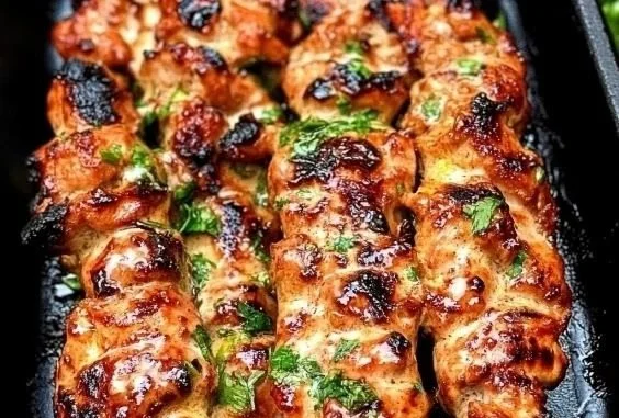 Delicious Bang Bang Chicken Skewers ready to serve on a plate