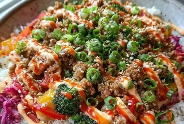 Delicious Bang Bang Ground Turkey Rice Bowls topped with fresh ingredients.
