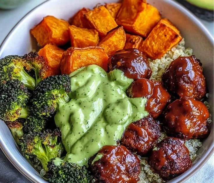Delicious barbecue meatball bowls with avocado goddess sauce served in a colorful bowl