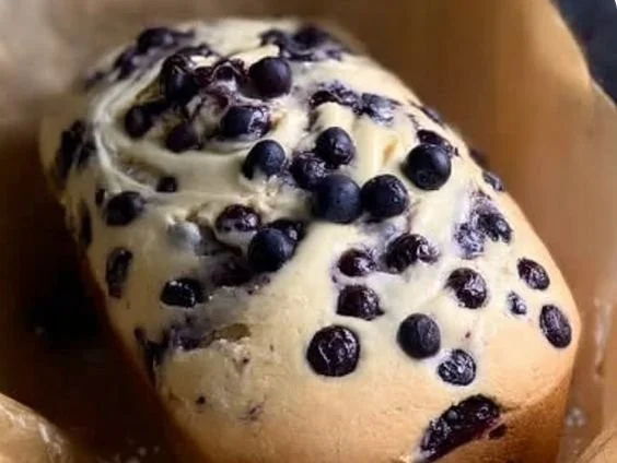 Freshly baked Blueberry Cream Cheese Loaf with blueberries on top