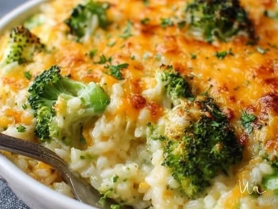 Baked broccoli cheese rice casserole in a white dish, topped with melted cheese.