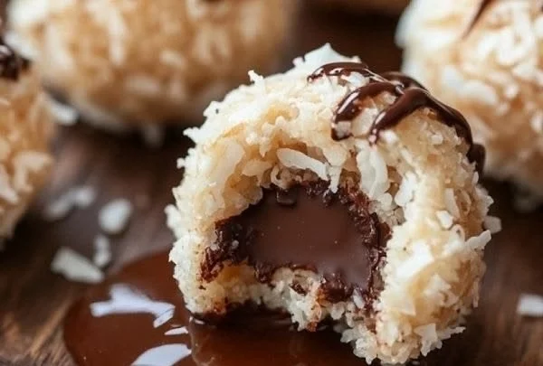 Homemade Chocolate Coconut Bliss Balls on a white plate, ready to enjoy.