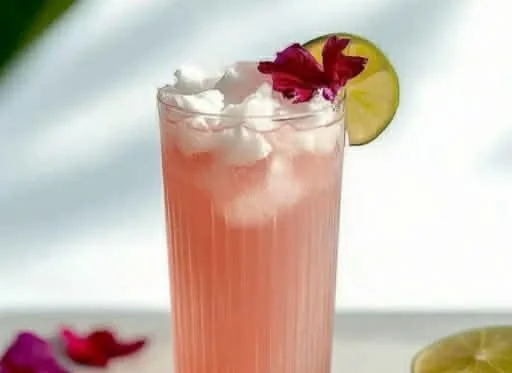 Coconut Hibiscus Breeze Mocktail served in a tropical setting with colorful garnishes