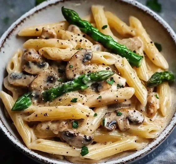 Creamy mushroom and asparagus chicken penne served in a bowl