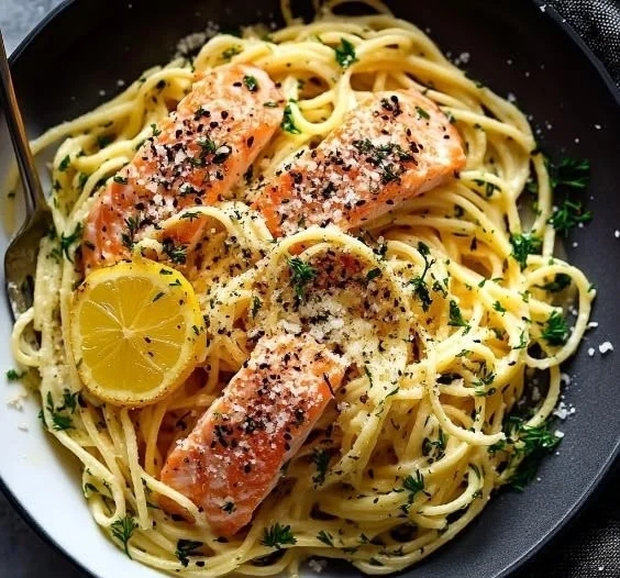 Delicious creamy salmon pasta sprinkled with herbs and served in a bowl.