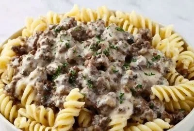 Delicious Hamburger Stroganoff served in a bowl with pasta and herbs.