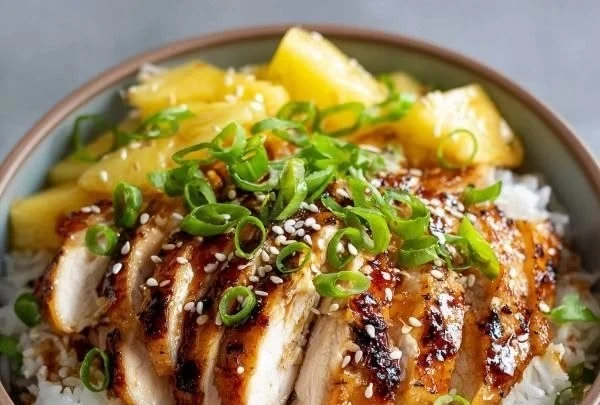 Plate of Hawaiian Chicken served with coconut rice and fresh vegetables.