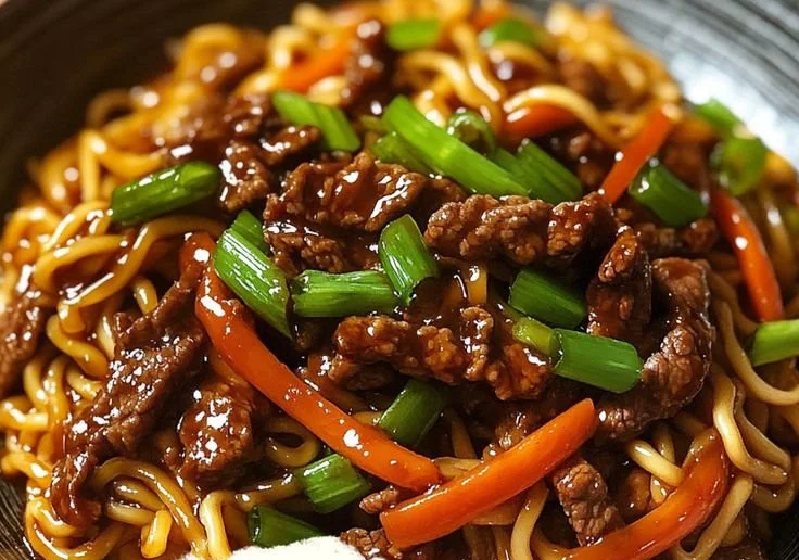 Delicious Hoisin Beef Noodles served in a bowl with fresh vegetables.