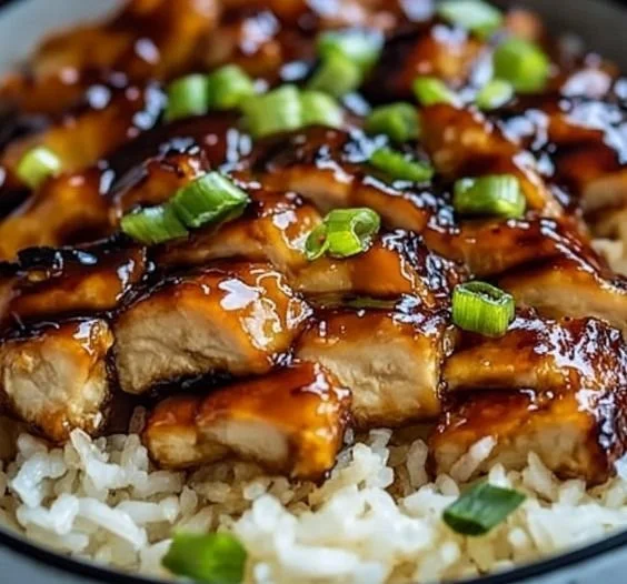 Honey BBQ Chicken served over rice, garnished with green onions
