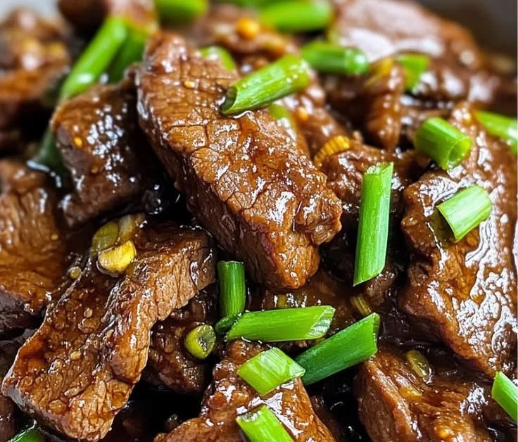 Slow Cooker Mongolian Beef ready for serving with vegetables and rice.