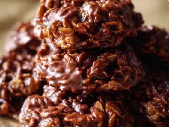 Delicious no-bake cookies displayed on a plate with chocolate and nuts.