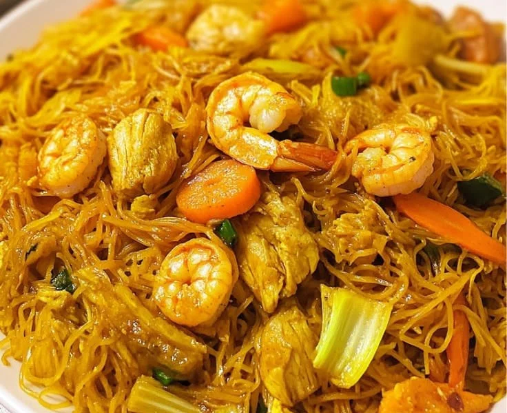 Plate of Singapore Noodles Mei Fun with colorful vegetables and shrimp