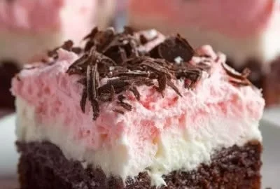 Delicious Sno Ball Brownies topped with powdered sugar on a plate.