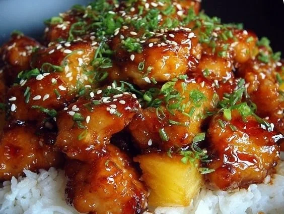 Delicious Sticky Teriyaki Pineapple Chicken served with fresh garnishes