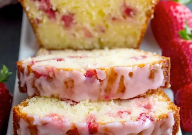 Delicious Strawberry Pound Cake topped with fresh strawberries and whipped cream