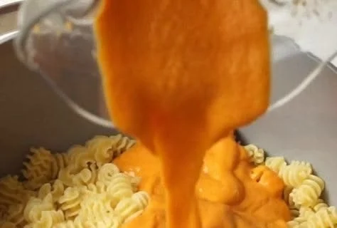 Vegan butternut squash pasta sauce poured over pasta