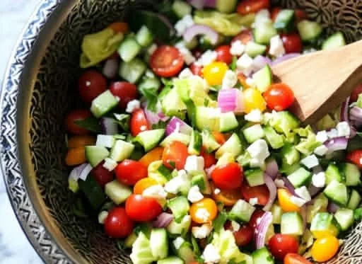 Vibrant spring chopped salad with colorful vegetables and herbs