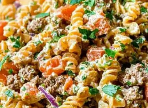 Colorful zesty taco pasta salad in a bowl with fresh ingredients