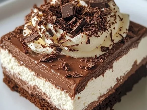 Chocolate cottage cheese mousse in a bowl topped with chocolate shavings.