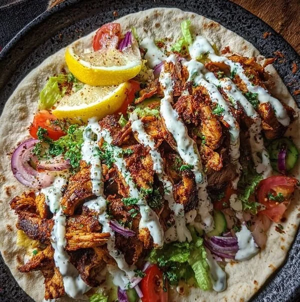 Garlic-Sauced Chicken Shawarma served with fresh vegetables and pita