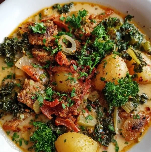Bowl of Vegan Zuppa Toscana soup with kale, potatoes, and spices